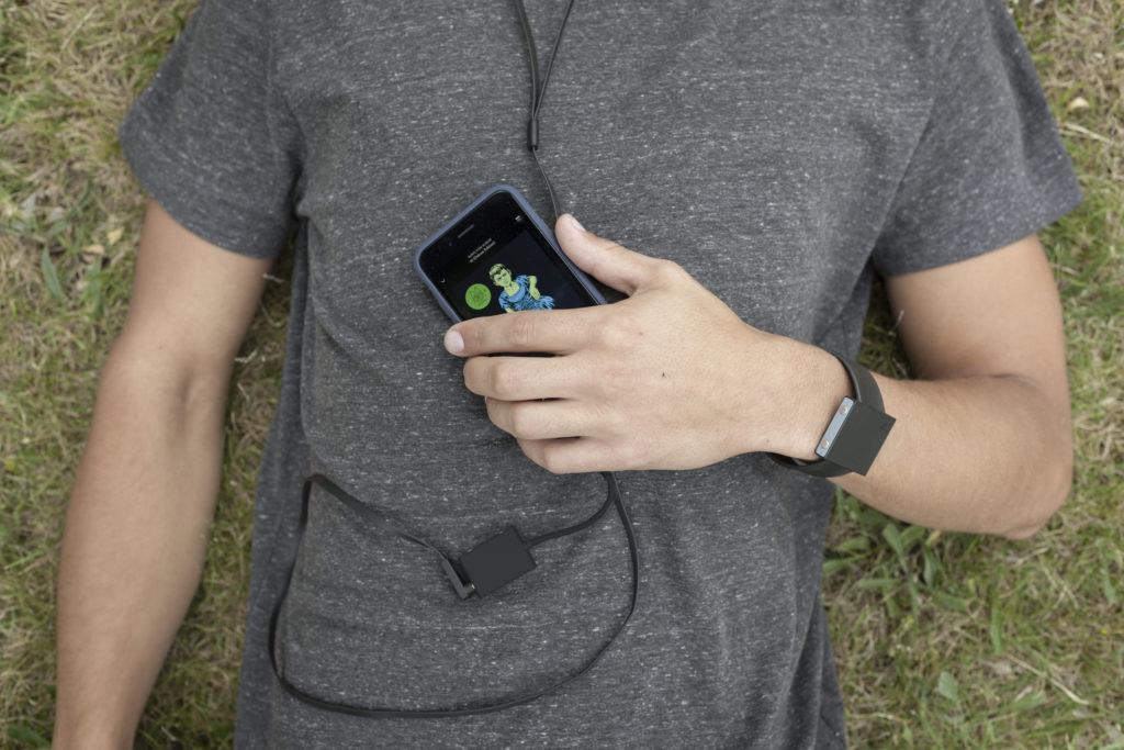 Man lying dow with Basslet wearable subwoofer