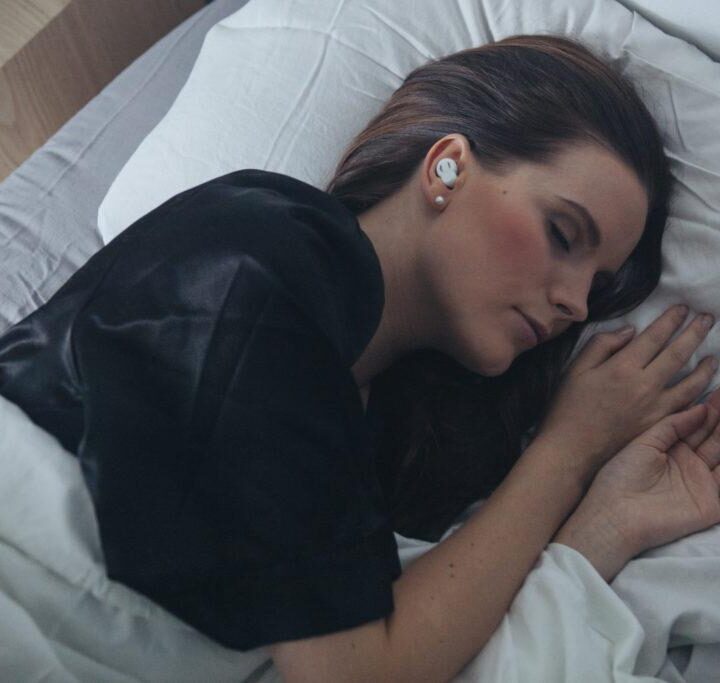 Person sleeping with QuietOn noise cancelling headphones