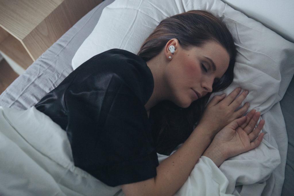 Person sleeping with QuietOn noise cancelling headphones