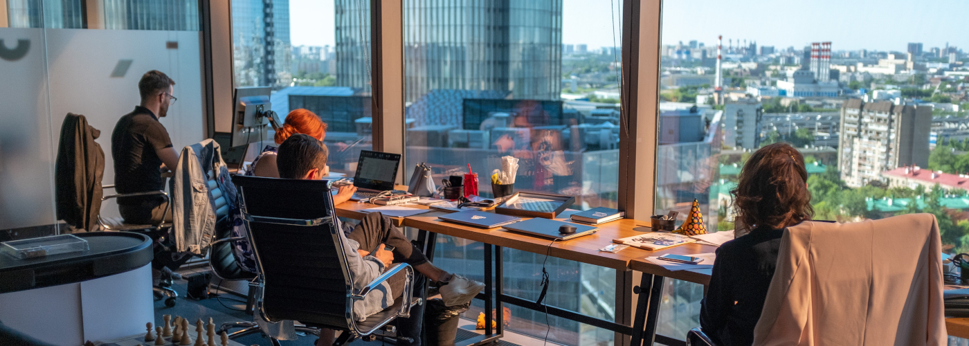 employees in an office with a view, an example of great employee experience