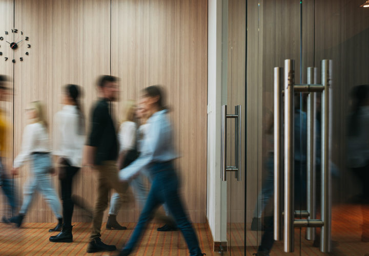 people walking in a busy office with a people counter