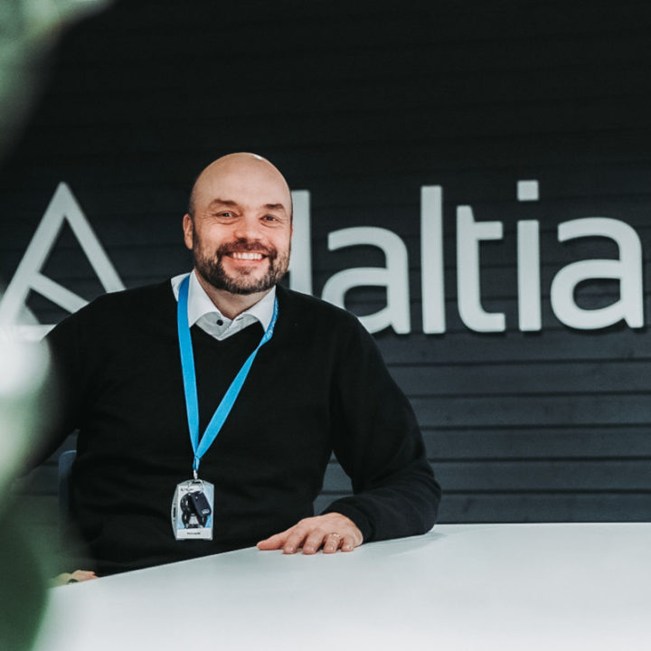 Pasi Leipälä, the CEO of Haltian, sitting down in front of Haltian logo.
