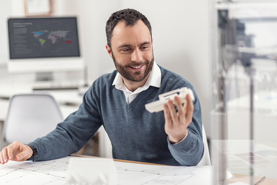 creating a protoype, man holding a product prototype in hand