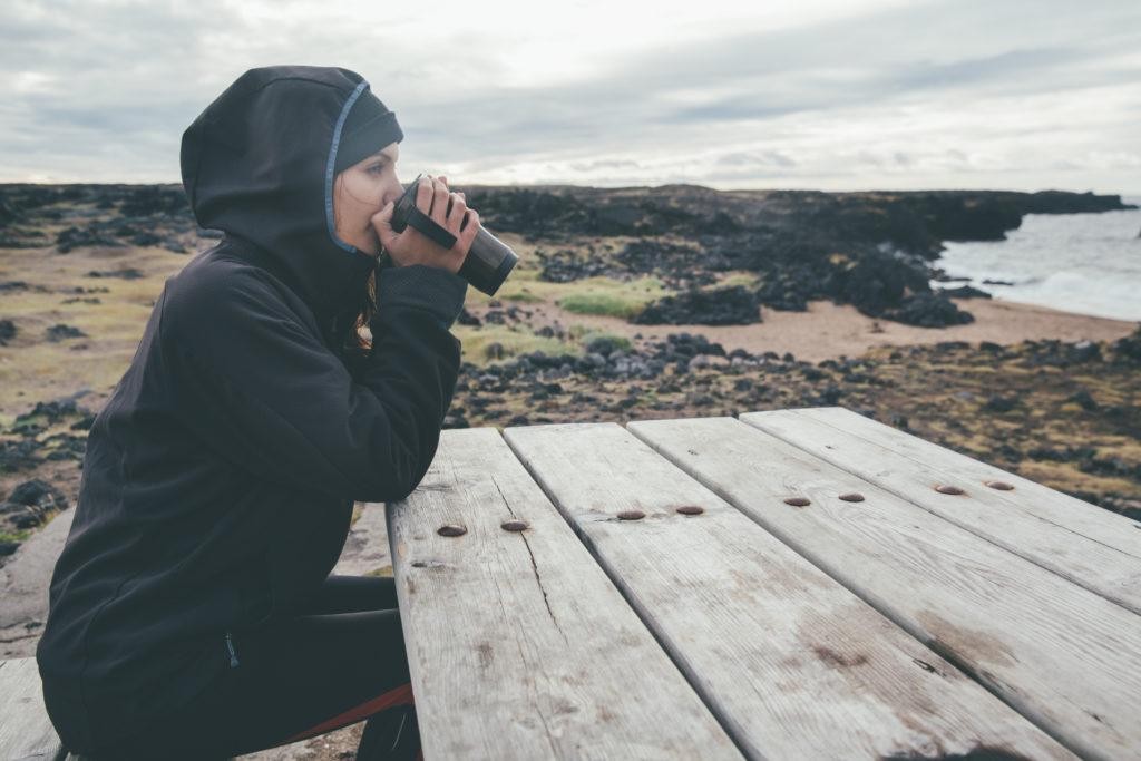 Woman drinking while wearing a Gore jacket