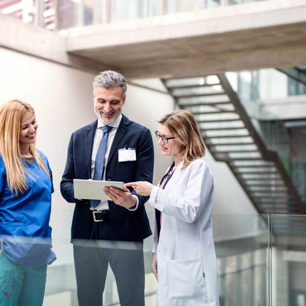 Hospital manager and workers looking at the data about the hospital operations