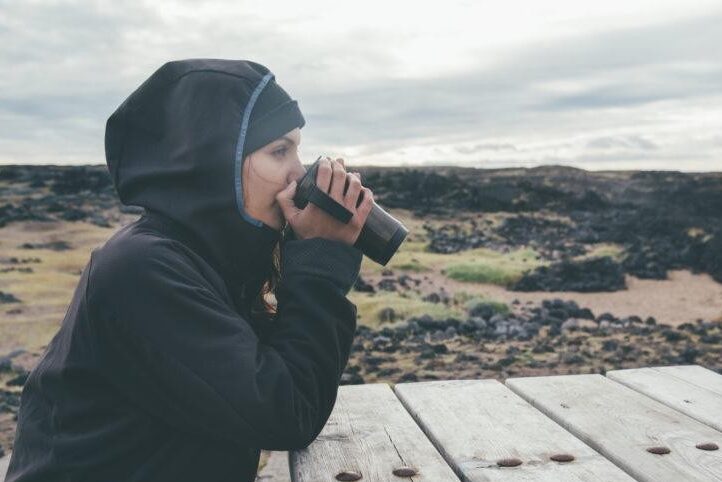 Woman drinking while wearing a Gore jacket